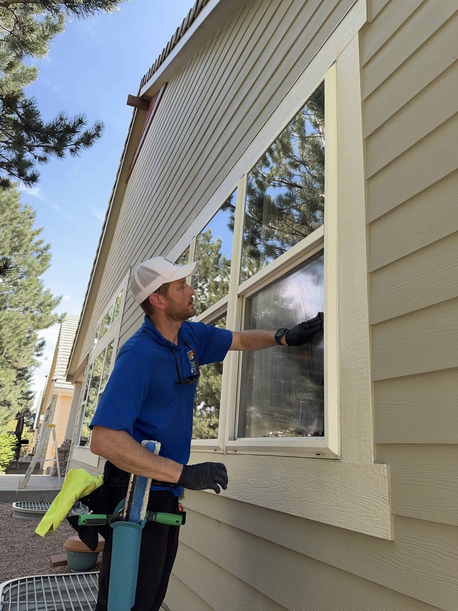 Technician performing window cleaning in Longmont CO